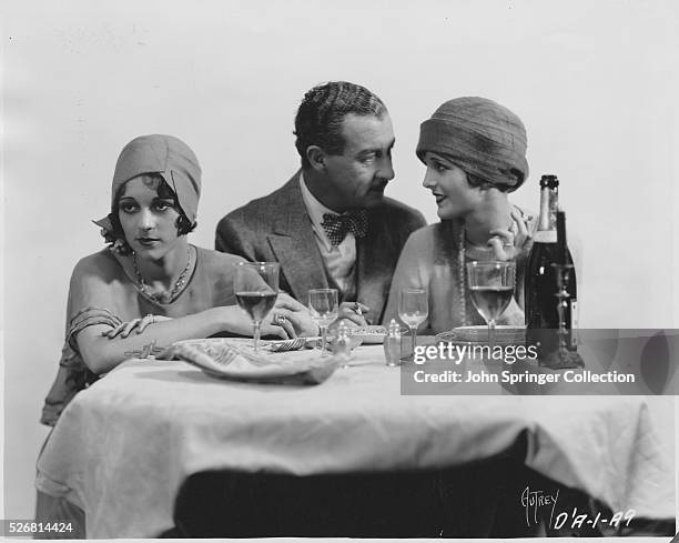 Actresses and actor in a scene from Dry Martini. Left to right: Sally Eilers; Albert Conti and Mary Astor