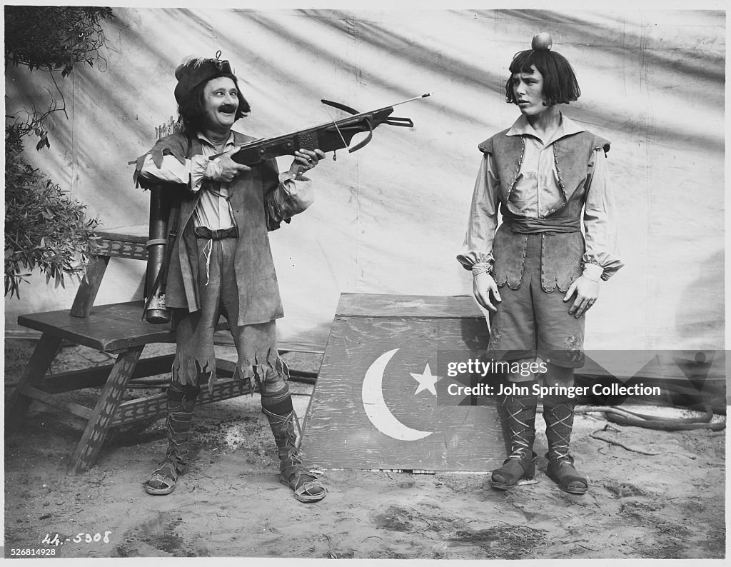 Ben Turpin Aiming Crossbow at Frank Coghlan, Jr