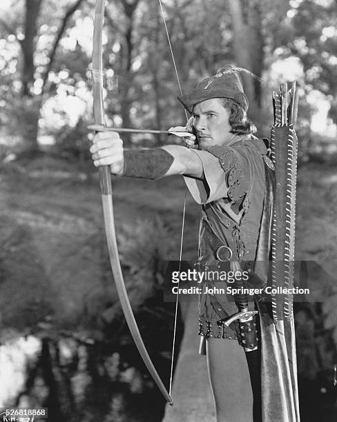 Robin Hood steadies his bow in Warner Brothers' film The Adventures of Robin Hood.