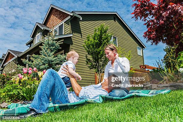 happy family of three at home - suburban family stock pictures, royalty-free photos & images