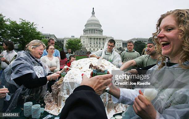 Elizabeth McDonough , who works for Ben and Jerry's ice cream company, hands out part of a 1,140 pound Baked Alaska which was made from Fossil Fuel...