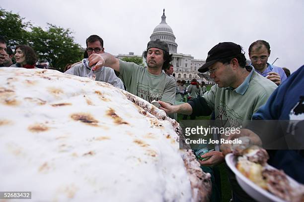 Arnold Carbone , who works for Ben and Jerry's ice cream company, digs into a 1,140 pound Baked Alaska which was made from Fossil Fuel ice cream...