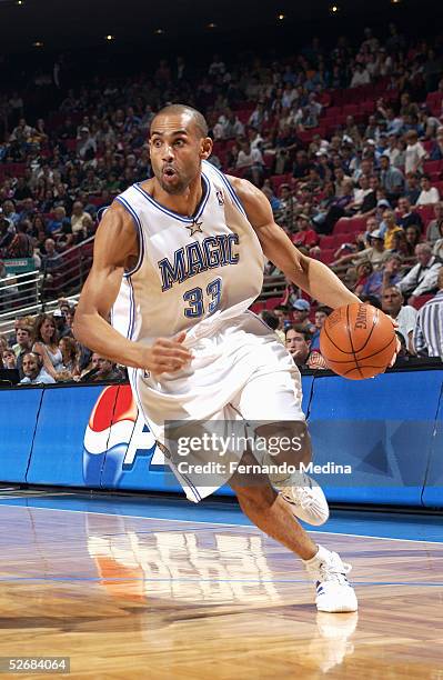 Grant Hill#33 of the Orlando Magic drives down the baseline against the Phoenix Suns March 26, 2005 at TD Waterhouse Centre in Orlando, Florida. The...