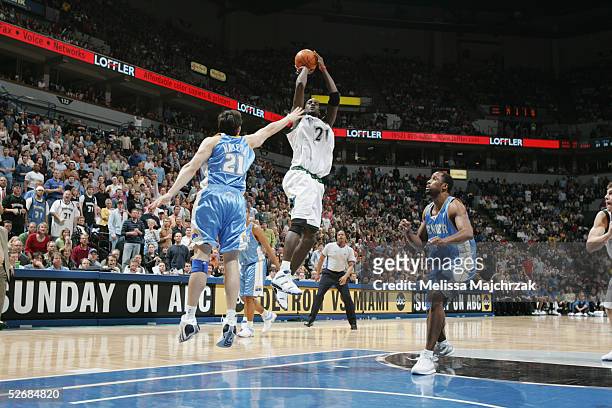 Kevin Garnett of the Minnesota Timberwolves shoots over Eduardo Najera of the Denver Nuggets during the game at Target Center on April 8, 2005 in...