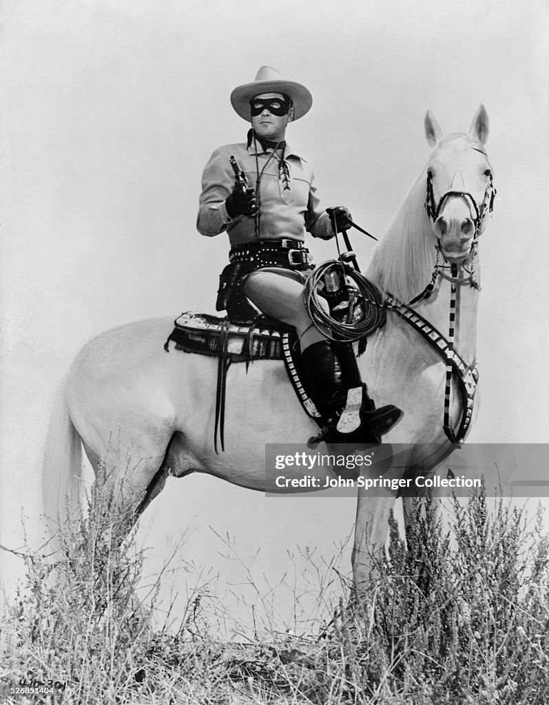 Clayton Moore sits on his horse with gun in a scene from The Lone Clayton Moore sits on his horse with gun in a scene from The Lone