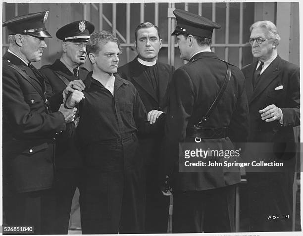 JAMES CAGNEY AND PAT O'BRIAN AS A CHAPLIN IN THE 1938 PRISON FILM "ANGELS WITH DIRTY FACES".