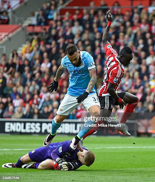 Joe Hart of Manchester City makes a save from Sadio Mane of Southampton with Nicolas Otamendi of Manchester City during the Barclays Premier League...