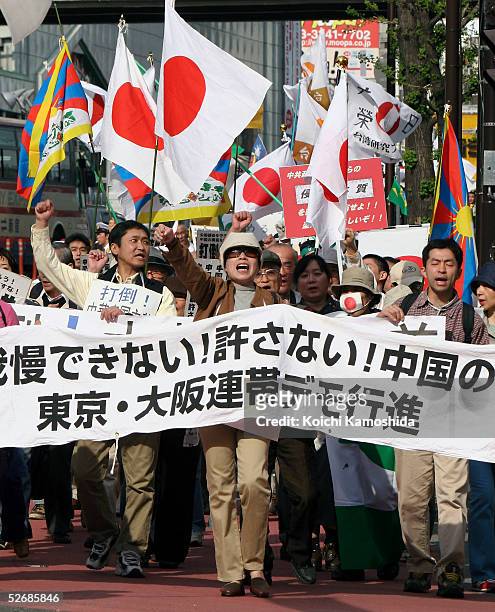 Anti-China protesters from Taiwan and Tibet living in Japan and rightish Japanese shout slogans and carry the Japanese flag during a demonstration in...