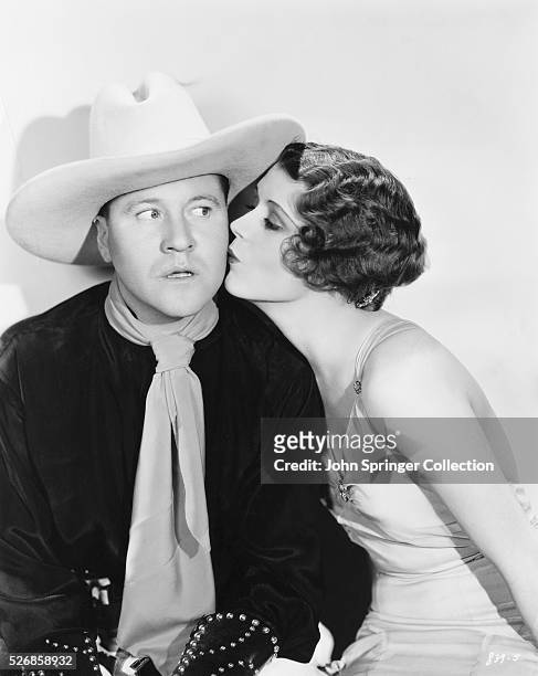 Jack Oakie receives a kiss on the cheek from June Collyer in the 1931 comedic western Dude Ranch.