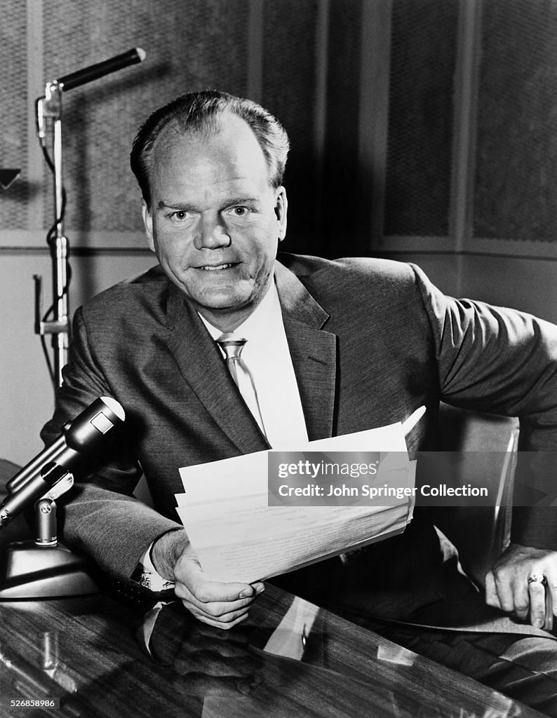 Broadcaster Paul Harvey Sitting with Microphone