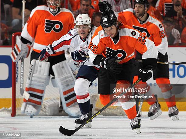Ryan White of the Philadelphia Flyers skates against T.J. Oshie of the Washington Capitals in Game Six of the Eastern Conference First Round during...