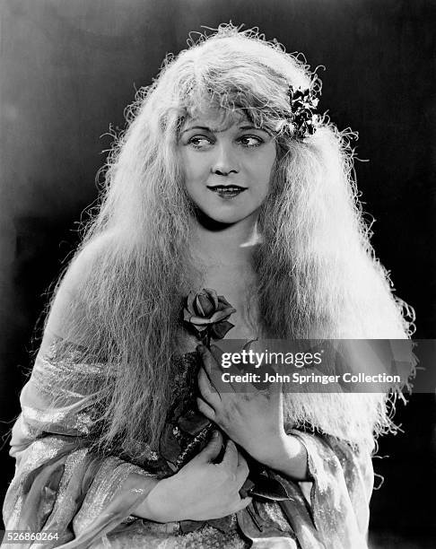 Actress Ann Harding Holding Rose