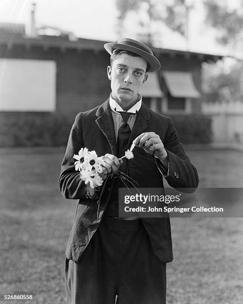 Actor Buster Keaton Picking Petals