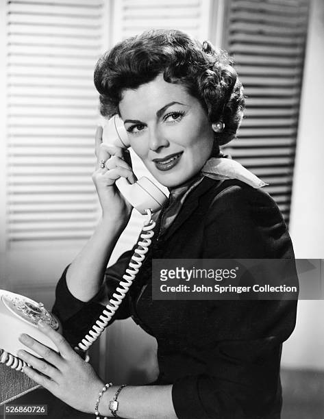 Barbara Hale answers the phone as Della Street, Perry Mason's dedicated secretary on the television series Perry Mason. Aired: 1957-1966.