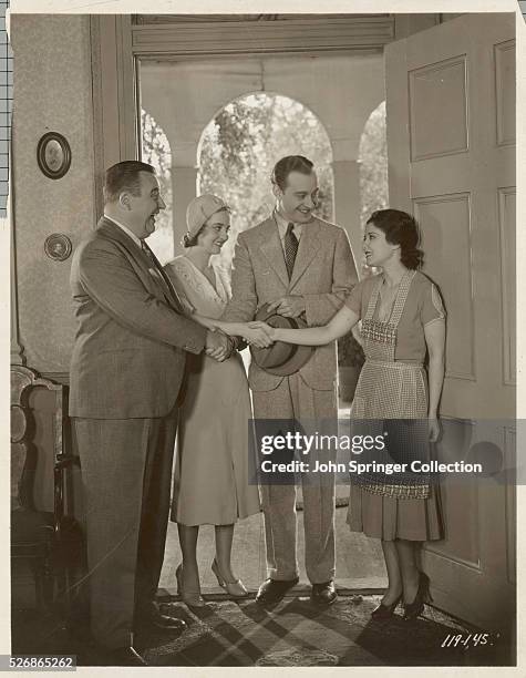 Bert Roach, Bette Davis, Conrad Nagel and Sidney Fox all shake hands in a scene from The Bad Sister.