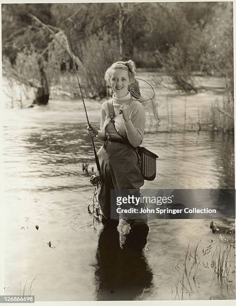 Actress Bette Davis on an annual fishing expedition in the California mountains.