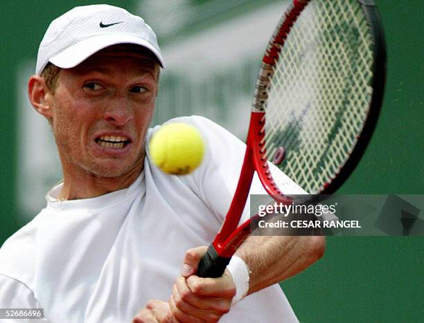 Russian Nikolai Davidenko returns a ball to Spanish Juan Carlos Ferrero during their ATP tennis tournament match at the Real Club Tennis Barcelona,...