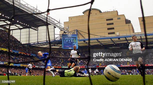 Chelsea's Eidur Gudjohnsen shoot past Fulham goalkeeper Edwin van der Sar to score their third goal in their Premiership match at Stamford Bridge in...