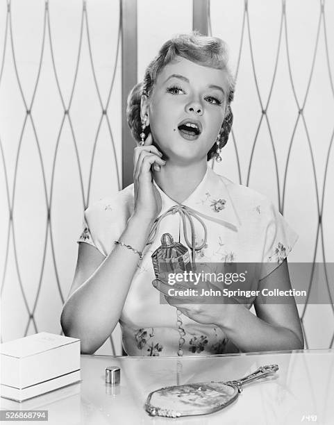 Actress Anne Francis Applying Perfume