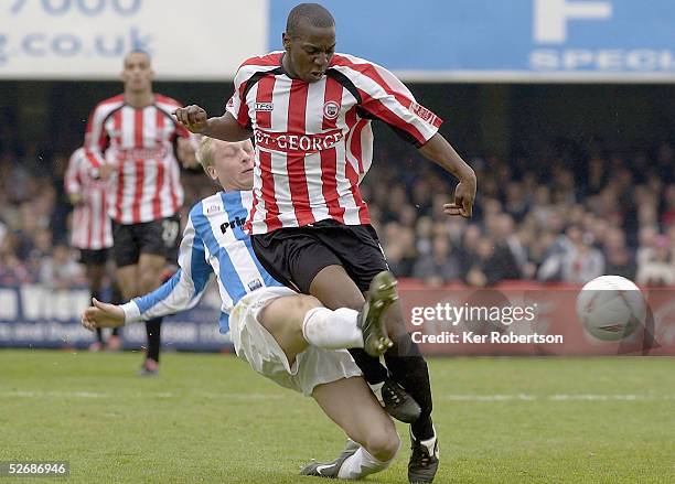 Isaiah Rankin of Brentford is challenged by Tom Clarke of Huddersfield Town during the Coca-Cola League One match between Brentford and Huddersfield...