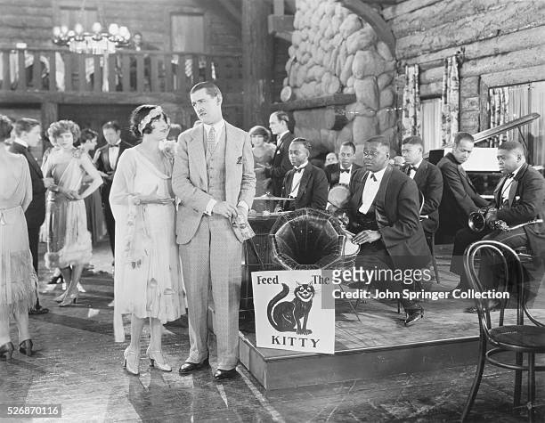 Mildred Harris tells Charley Chase to pay the band at a nightclub.