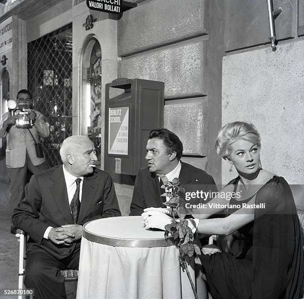 Swedish actress Anita Ekberg, Italian producer and publisher Angelo Rizzoli with director and screenwriter Federico Fellini the last day of the set...