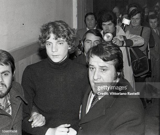 John Paul Getty III is escorted by plainclothes police as he arrives at Rome's Police Headquarters. Eldest of the four children of John Paul Getty,...