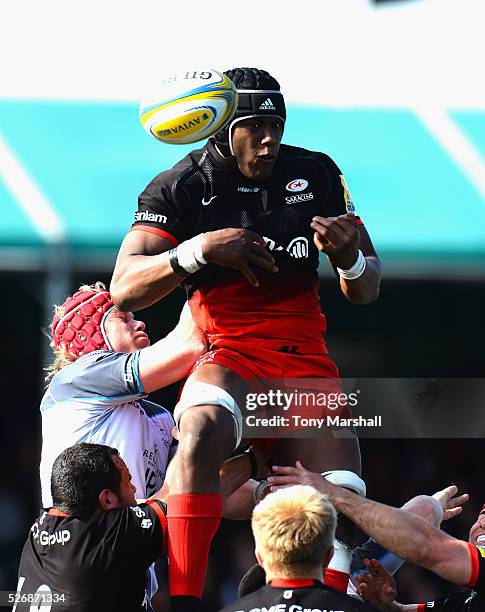 Maro Itoje of Saracens is tackled by Mouritz Botha of Newcastle Falcons during the Aviva Premiership match between Saracens and Newcastle Falcons at...