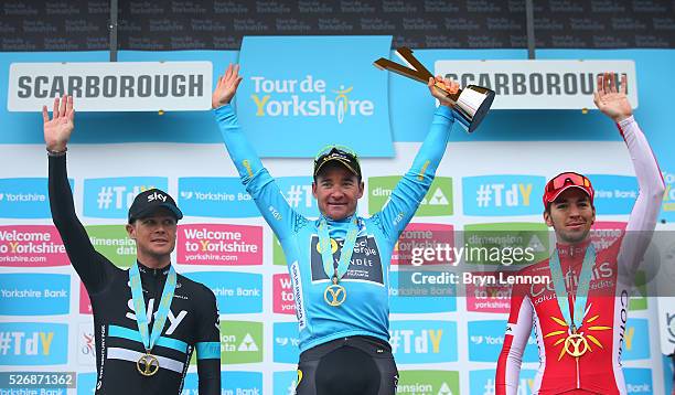 Overall winner Thomas Voeckler of Direct Energie and France celebrates with Nicolas Roche of Team Sky and Ireland and Anthony Turgis of Cofidis,...