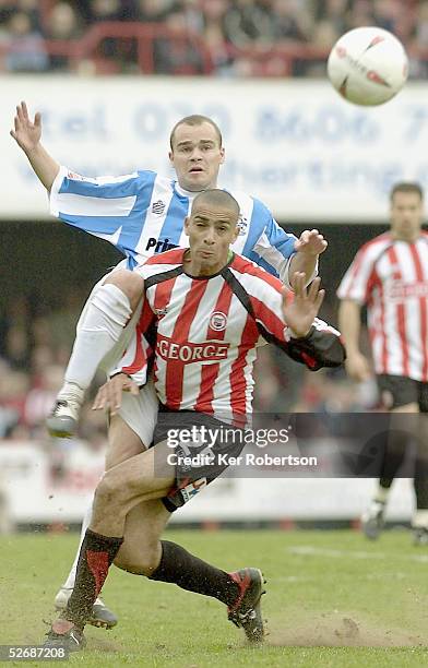 Darren Pratley of Brentford holds off Lee Fowler of Huddersfield Town during the Coca-Cola League One match between Brentford and Huddersfield Town...