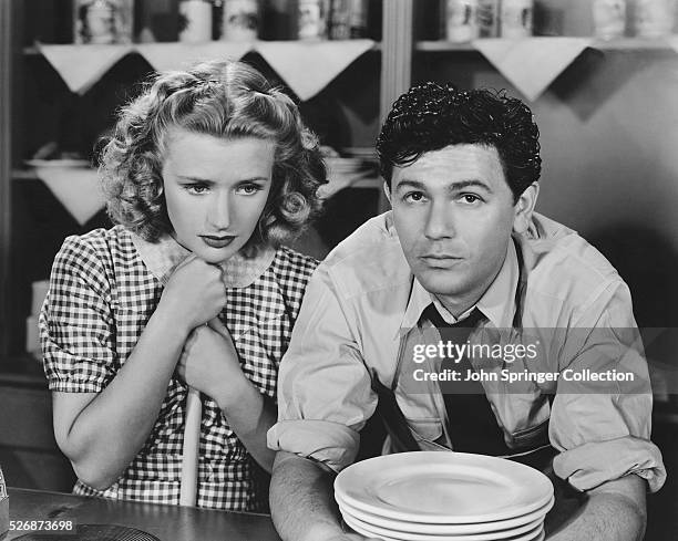 Priscilla Lane and John Garfield consider their future in this scene from the 1939 motion picture Dust Be My Destiny.