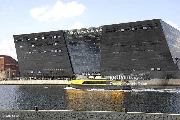Danish royal library is famous by the name Black Diamond this building is part of old library and on Copenhagen habour and at behind is seen danish...