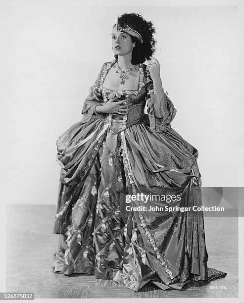 Elsa Lanchester wears one of several elaborate costumes as Madame d'Annard in the 1935 motion picture Naughty Marietta.