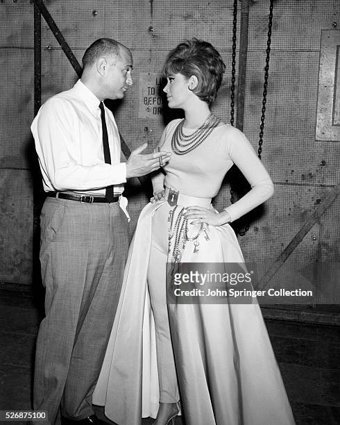Writer-producer Norman Lear talks to Actress Jill St. John on the set of the 1963 film Come Blow Your Horn, starring Frank Sinatra.