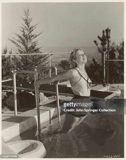 Actress Ida Lupino on Pool Ladder
