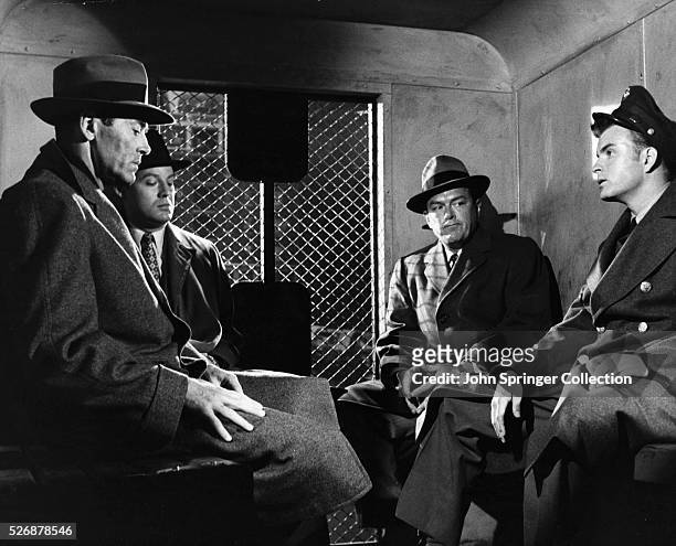 Manny Balestrero , far left, sits in the back of a police van with detectives in a scene from the 1956 Alfred Hitchcock film, The Wrong Man.