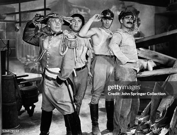 The Marx Brothers : Harpo, Chico, Zeppo and Groucho Marx salute on the set of their classic 1933 film Duck Soup. They play Pinky, Lt. Bob Roland,...
