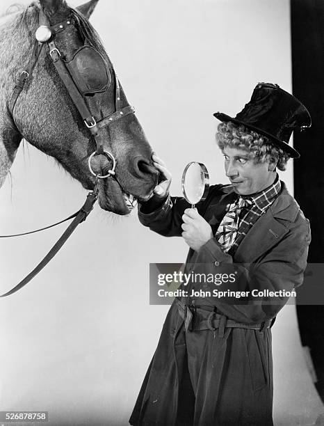 Harpo Marx Examining Horse with a Magnifying Glass