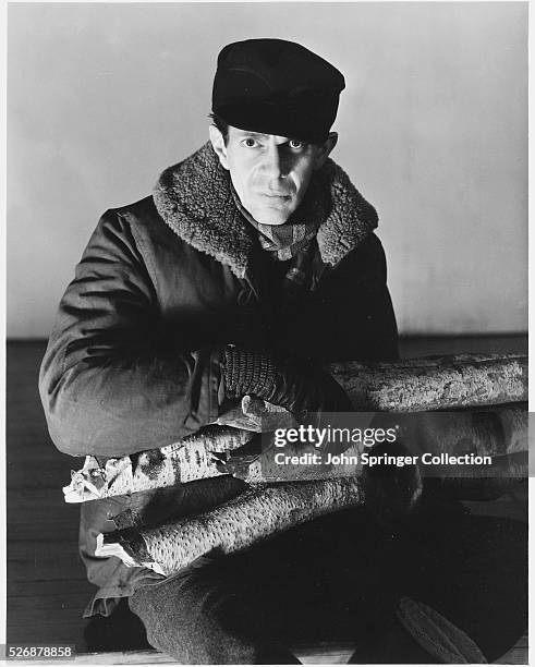 Actor Raymond Massey Carrying Firewood