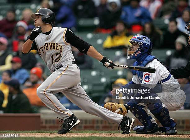 Freddy Sanchez of the Pittsburg Pirates hits a triple in the ninth inning to drive in the winning run in front of Michael Barrett of the Chicago Cubs...