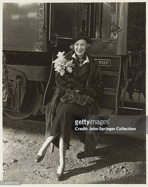 Actress and Singer Grace Moore Sitting on Steps of Railroad Car