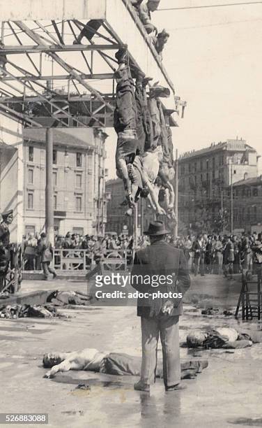 World War II. Benito Mussolini and his mistress Claretta Petacci hung by their feet in Piazzale Loreto in Milan . On April 1945.