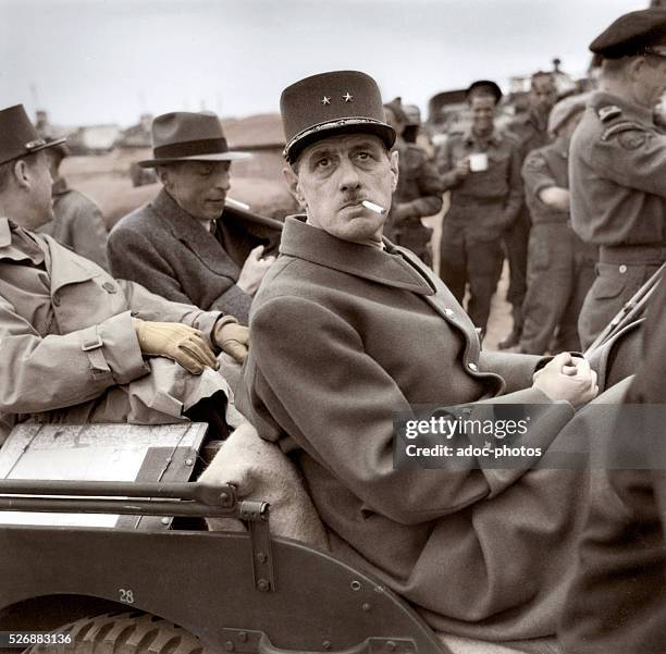 The French general Charles de Gaulle in a jeep few days after the Invasion of Normandy by the Allied forces. June 14, 1944. Coloured photograph.