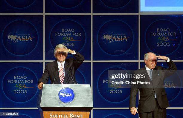 John Howard, Prime Minister of Australia , and Bob Hawke, former prime minister of Australia, gesture during the opening ceremony of the Boao Forum...