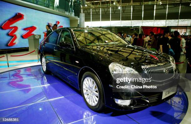 Chinese people view a Red Flag HQ3 limousine of China First Automobile Works Group at the Auto Shanghai 2005 Exhibition on April 23, 2005 in...