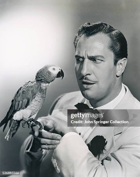 Actor Vincent Price Holding a Parrot