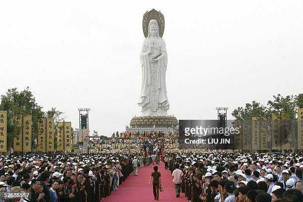 Sea of pilgrims gather under a giant statue of the Buddhist goddess of mercy or Guanyin in Chinese ahead an unveiling ceremony of Nanshan Guanyin...