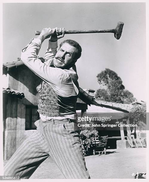 Actor Vincent Price Swinging a Sledgehammer