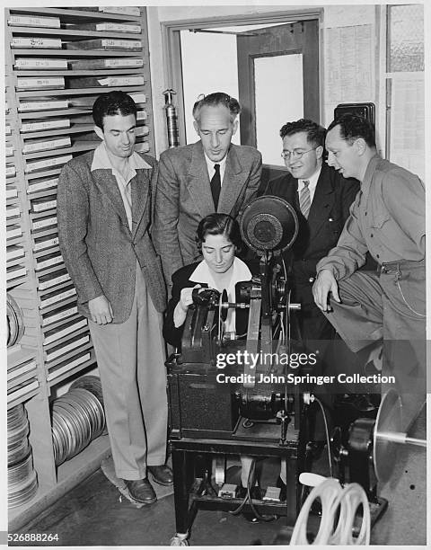 Film Editors Looking at Movie Clips, News Photo
