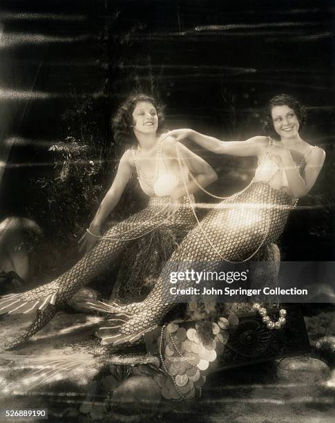 Actresses Lillian Roth and Frances Dee dressed as lovely mermaids of the sea. Frances Dee appears opposite Maurice Chevalier in his new production...